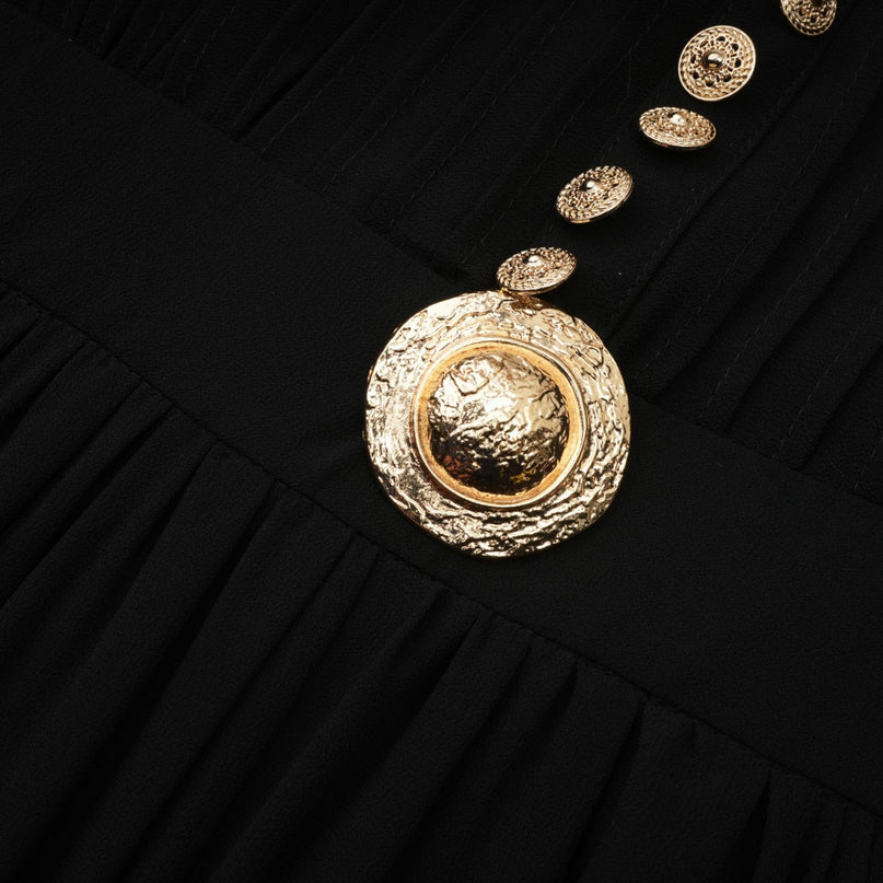 A black pleated midi dress with a buttonfront design and a fitted silhouette named Viviane