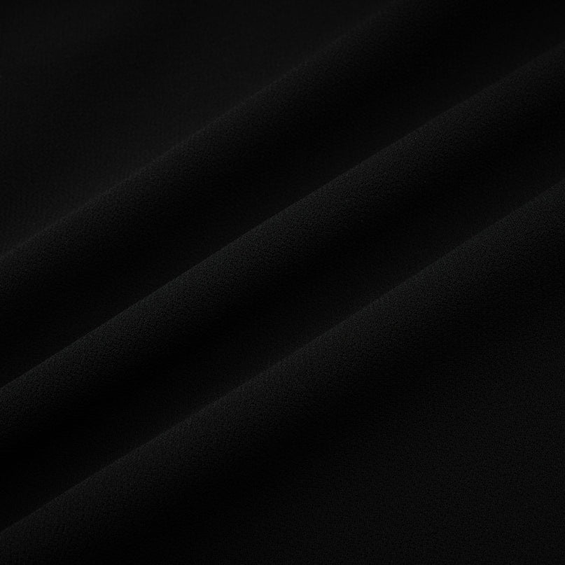 A black pleated midi dress with a buttonfront design and a flowing silhouette named Viviane