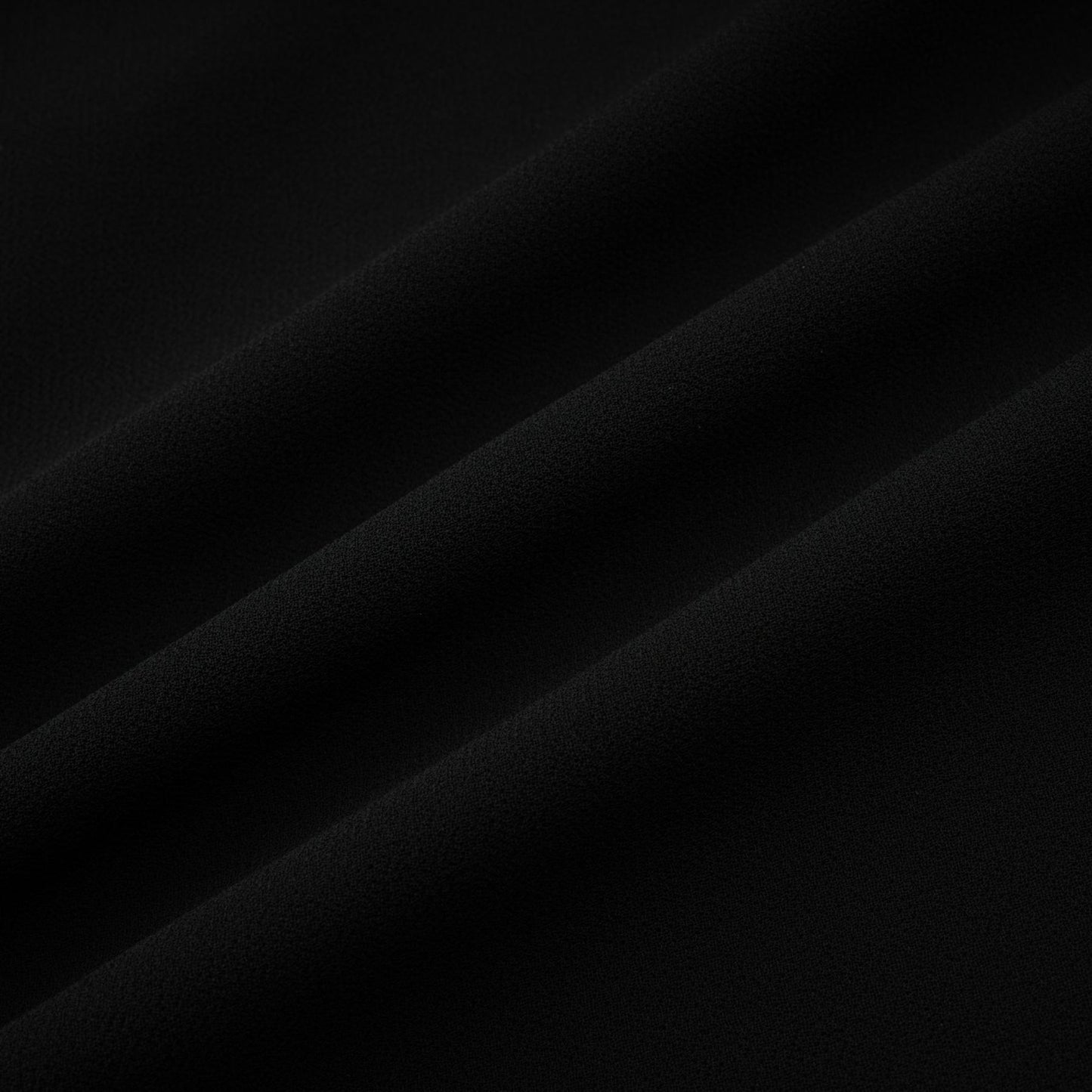 A black pleated midi dress with a buttonfront design and a flowing silhouette named Viviane