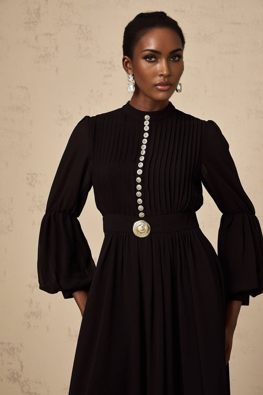 A black pleated midi dress with a buttonfront design and a sleek silhouette named Viviane