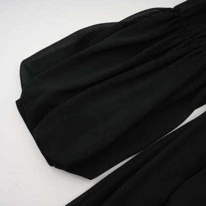 A black pleated midi dress with a buttonfront design featuring long sleeves and a fitted waist