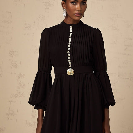 A black pleated midi dress with a buttonfront design featuring long sleeves and a flowy silhouette