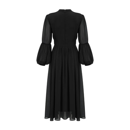 A black pleated midi dress with button front closure and sleeveless design featuring a fitted waist and flared skirt