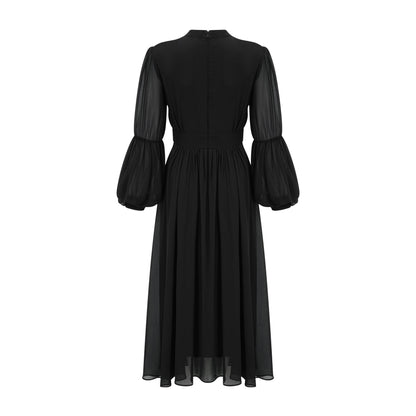 A black pleated midi dress with button front closure and sleeveless design featuring a fitted waist and flared skirt
