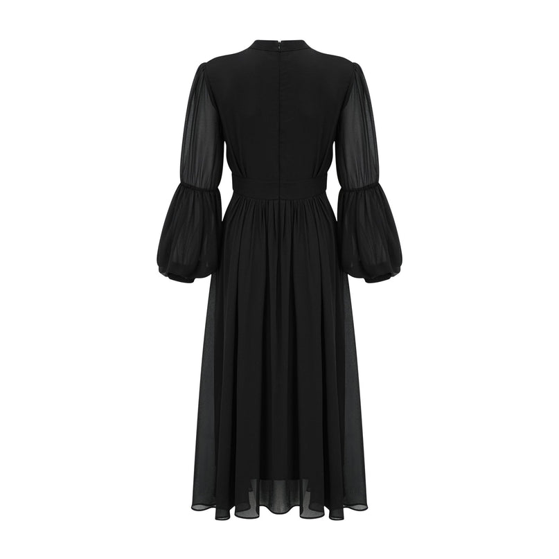 A black pleated midi dress with buttonfront closure featuring a feminine silhouette and Viviane design