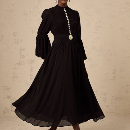 A black pleated midi dress with buttonfront detail and a feminine silhouette named Viviane