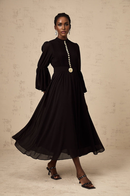 A black pleated midi dress with buttonfront detail and a feminine silhouette named Viviane