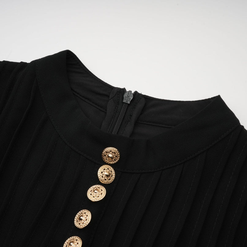 A black pleated midi dress with buttonfront detail and a fitted silhouette named Viviane