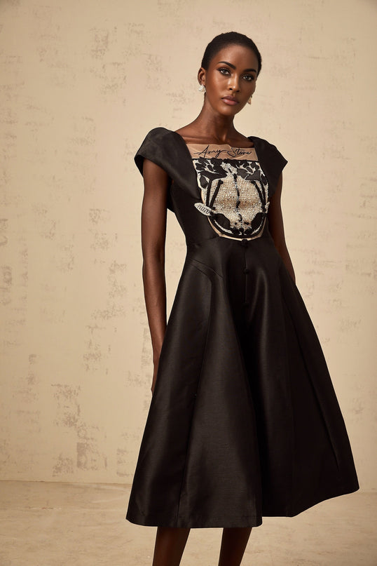 A black satin midi dress with floral applique details named Ulrique