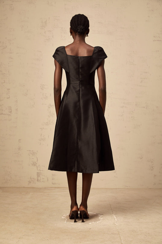 A black satin midi dress with floral applique details