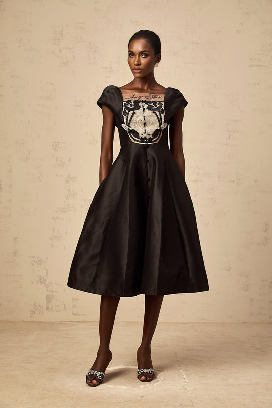 A black satin midi dress with floral applique details