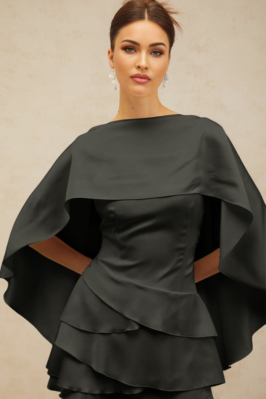 A black satin mini dress with ruffle details and a shawl panel featuring a sleek and elegant design perfect for formal occasions