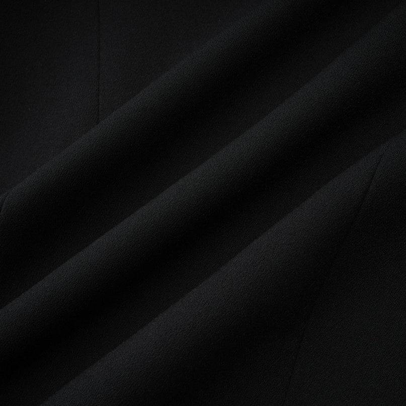 A black single breasted long coat by Aelle