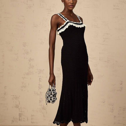 A black sleeveless midi dress with a crochet knit pattern