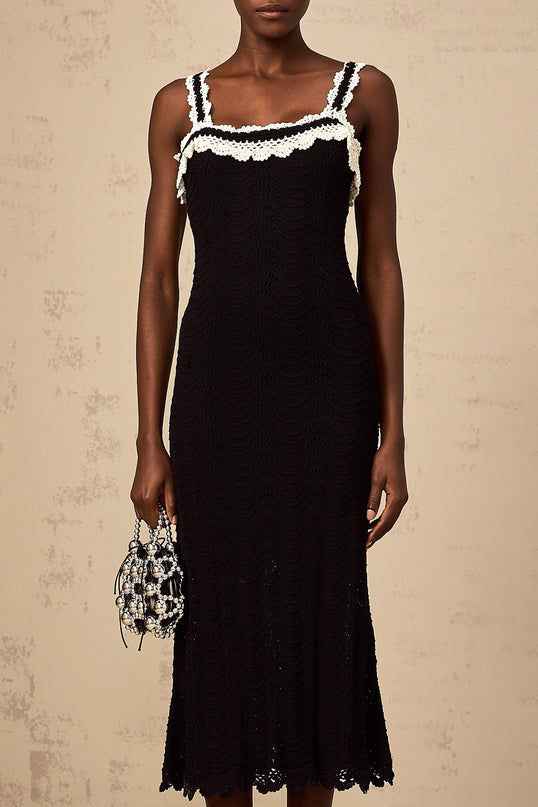 A black sleeveless midi dress with a crochet knit pattern