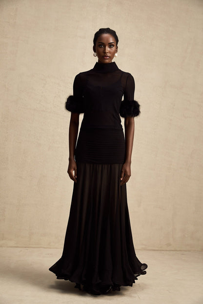 A black sleeveless top with a faux fur bodice and sheer tulle overlay creating a luxurious and elegant look