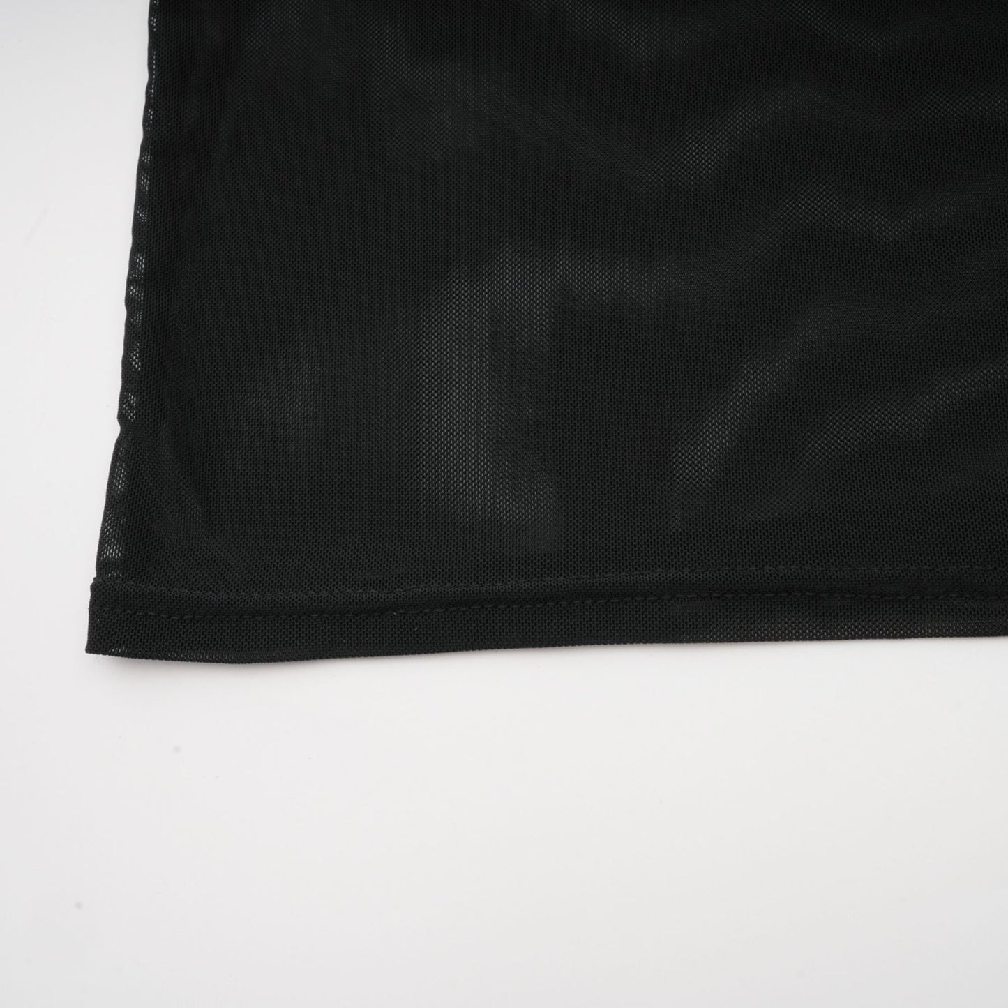 A black sleeveless top with a faux fur bodice and sheer tulle overlay