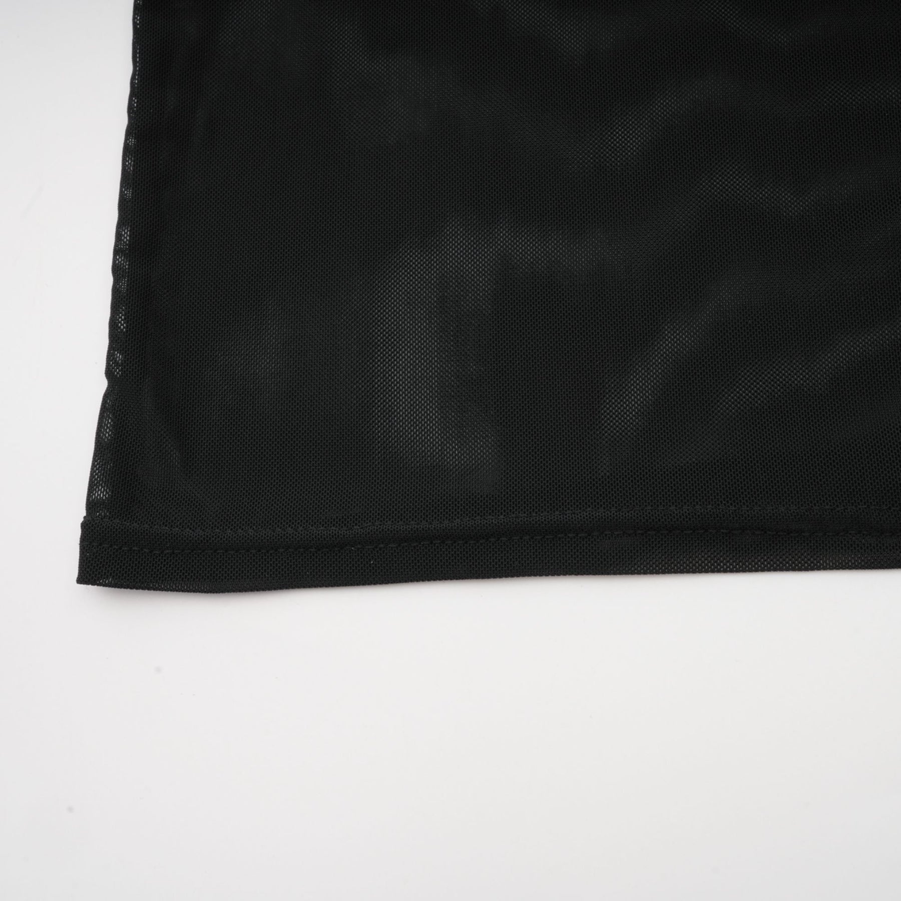 A black sleeveless top with a faux fur bodice and sheer tulle overlay