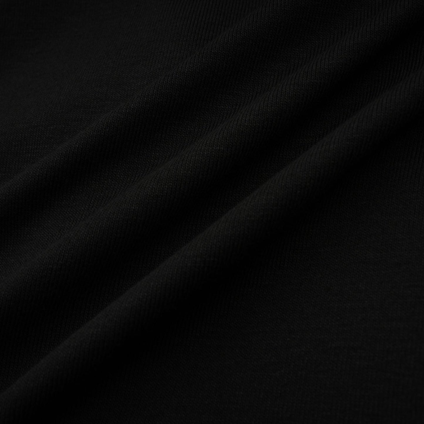 A black sleeveless top with an open front design and gathered fabric details