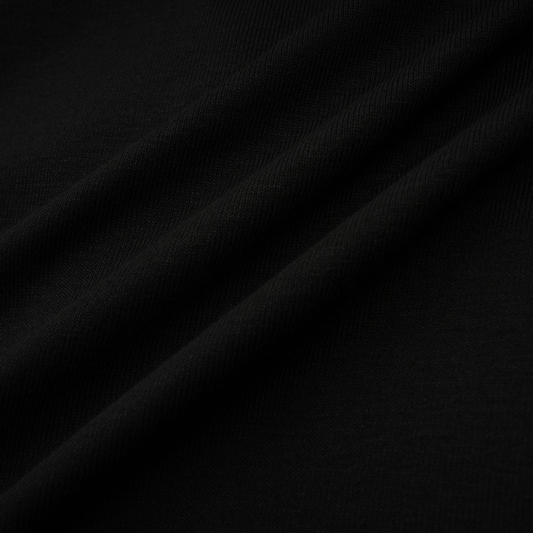 A black sleeveless top with an open front design and gathered fabric details