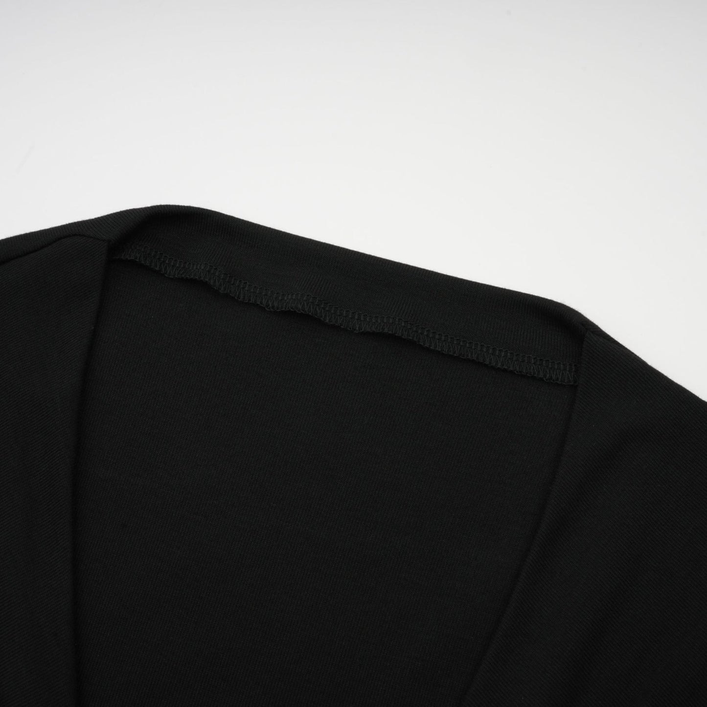 A black sleeveless top with an open front design featuring gathered fabric details