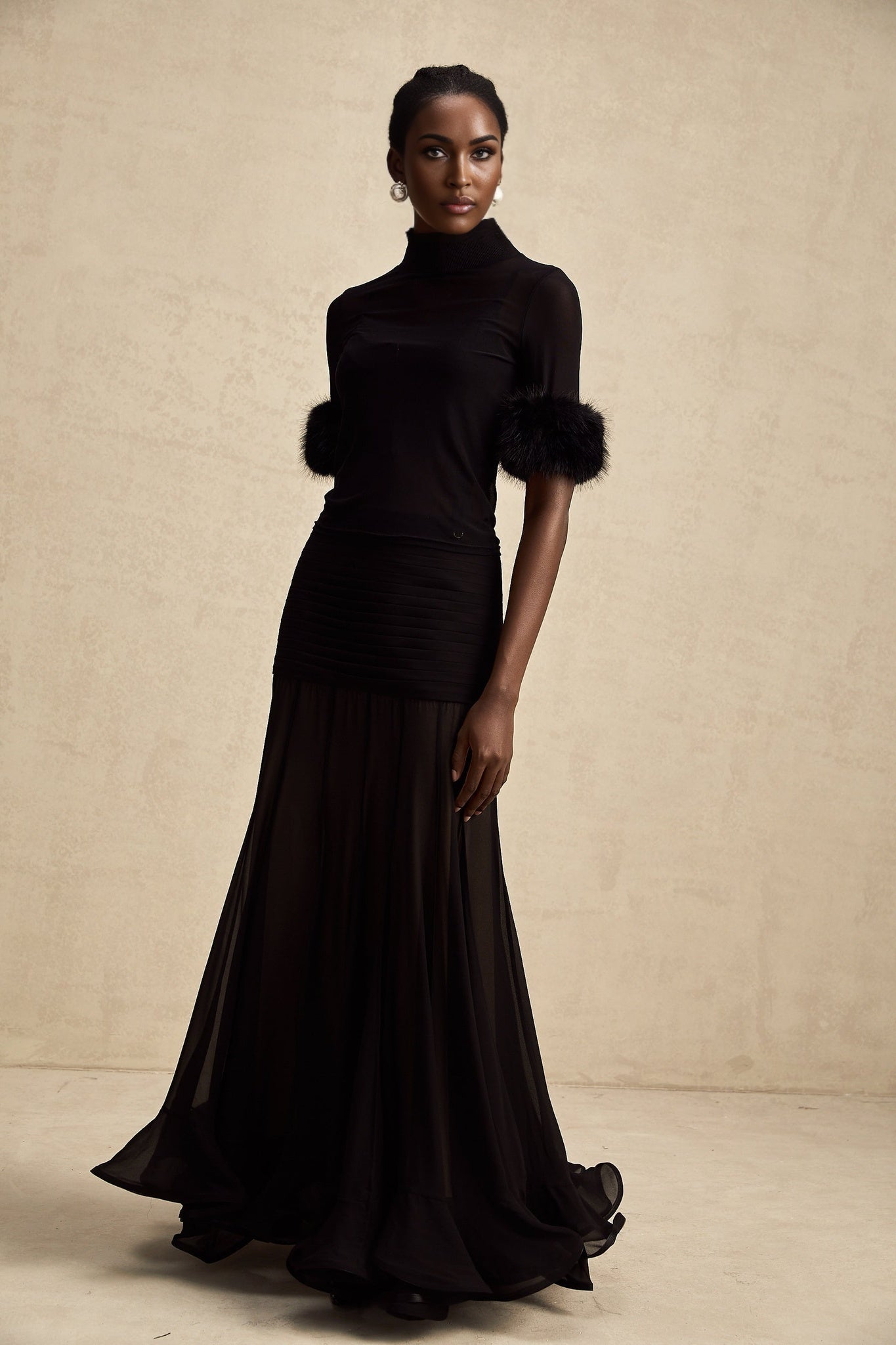 A black sleeveless top with faux fur trim and tulle overlay