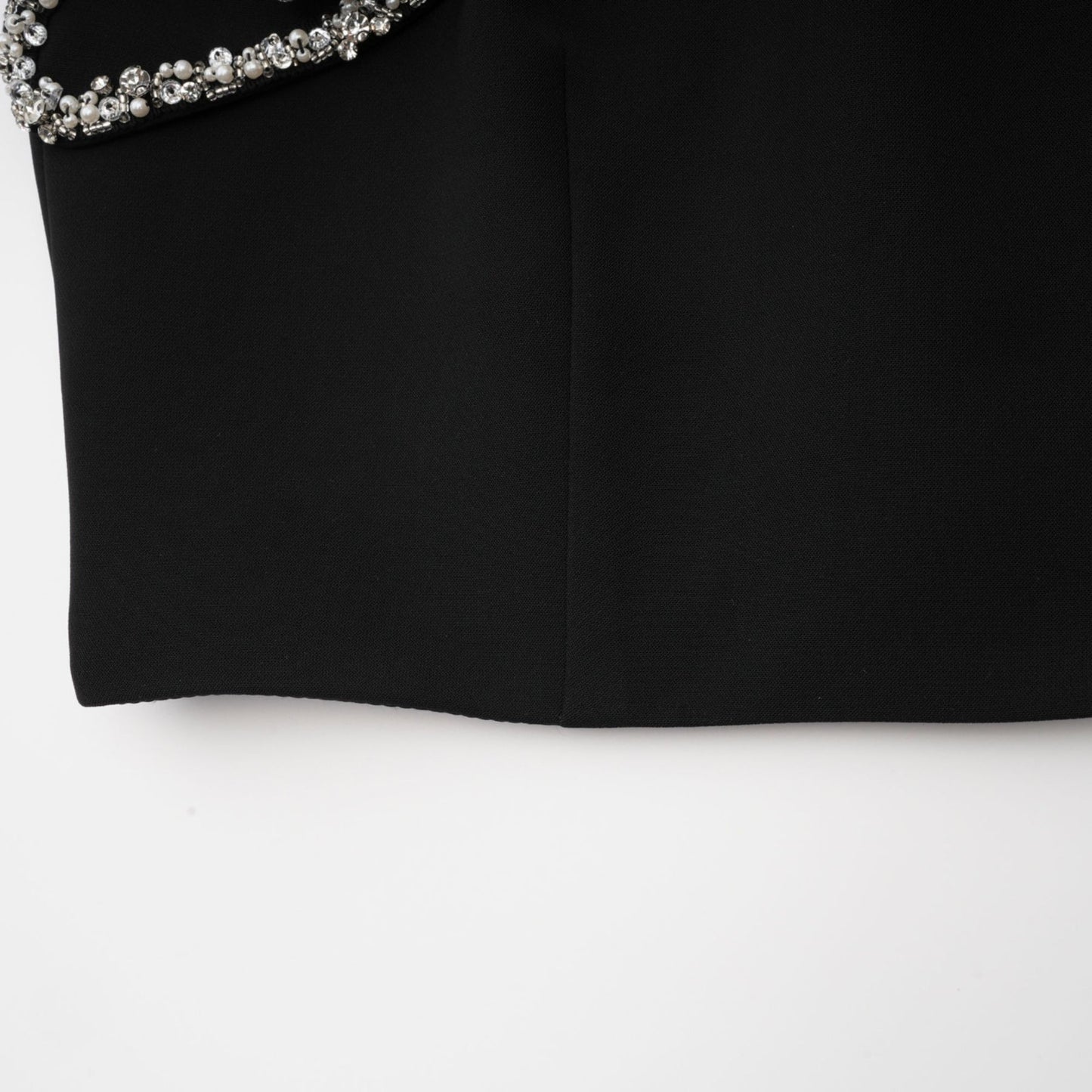 Black spaghetti strap dress with crystal and faux pearl embellishments ruffled details and a rear zip fastening