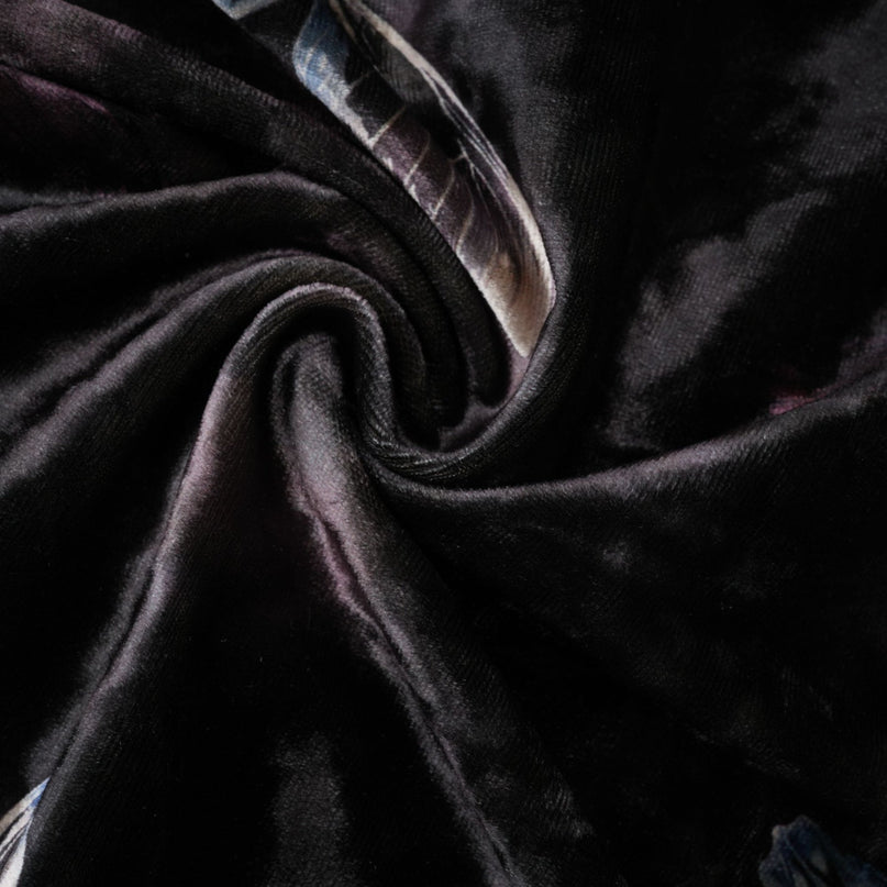 A black velvet midi dress with a butterfly print pattern and a feminine silhouette named Blanche