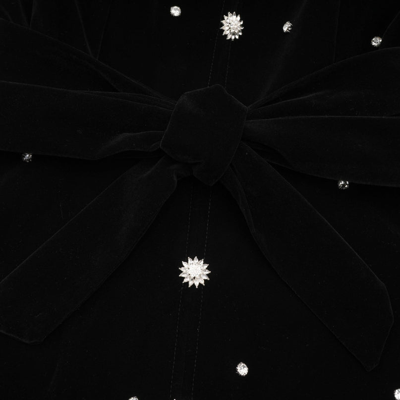 A black velvet midi dress with embellishments named Lola featuring a sleek silhouette and elegant design