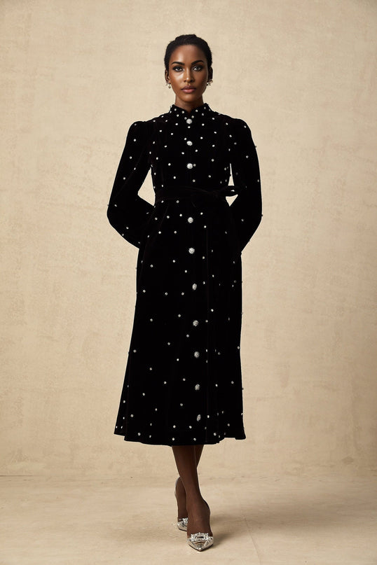 A black velvet midi dress with embellishments named Lola featuring a sleek silhouette and elegant design