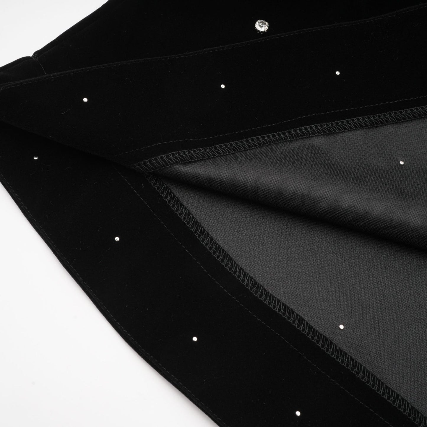 A black velvet midi dress with embellishments named Lola featuring a sleek silhouette and elegant design