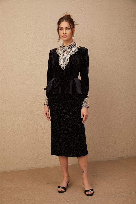 A black velvet midi dress with embellishments named Roxane featuring a fitted silhouette and elegant design