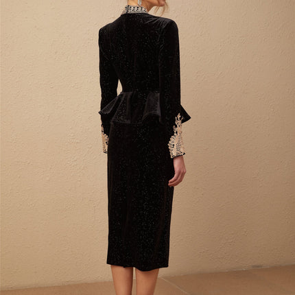 A black velvet midi dress with embellishments named Roxane featuring a sleek silhouette and decorative details