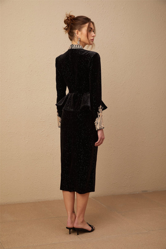 A black velvet midi dress with embellishments named Roxane featuring a sleek silhouette and decorative details