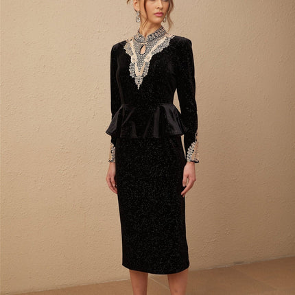 A black velvet midi dress with embellishments named Roxane featuring a sleek silhouette and elegant design