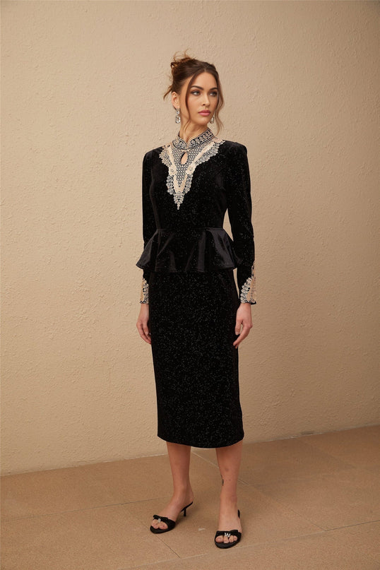 A black velvet midi dress with embellishments named Roxane featuring a sleek silhouette and elegant design