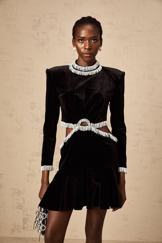A black velvet mini dress with cutout details and fringe accents named Daniela