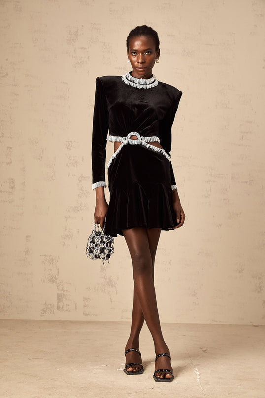 A black velvet mini dress with cutout details and fringe accents named Daniela