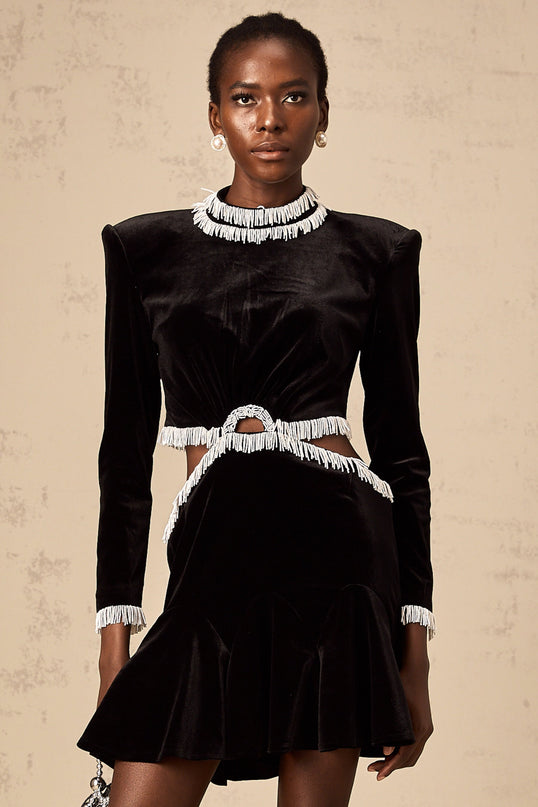 A black velvet mini dress with cutout details and fringe trim named Daniela