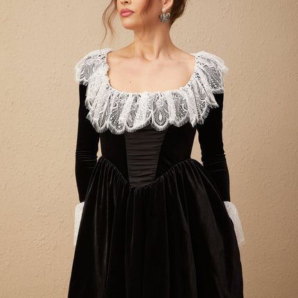 A black velvet mini dress with lace trim details and short length