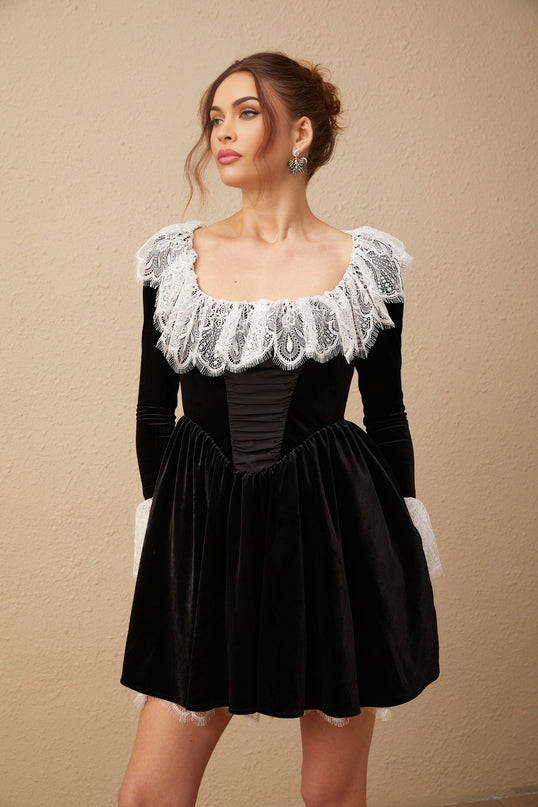 A black velvet mini dress with lace trim details and short length