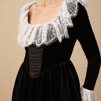 A black velvet mini dress with lace trim details called Fabiana