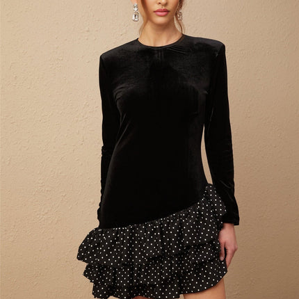 A black velvet mini dress with white polka dots featuring ruffled panels and a short hemline named Lucrezia