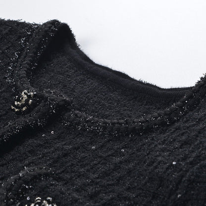 Black waffleknit dress with matching pleated skirt