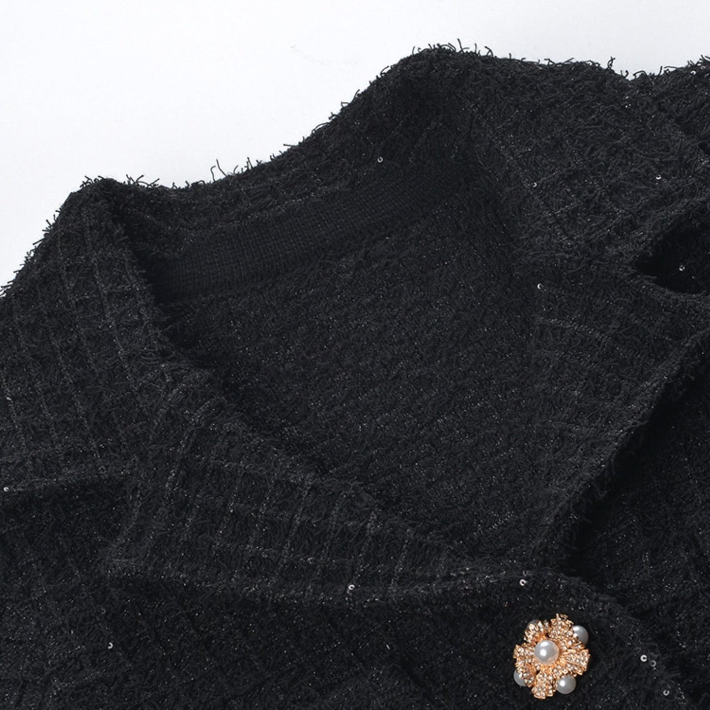 Waffleknit black dress with pleated edge thighlength and front button fastening