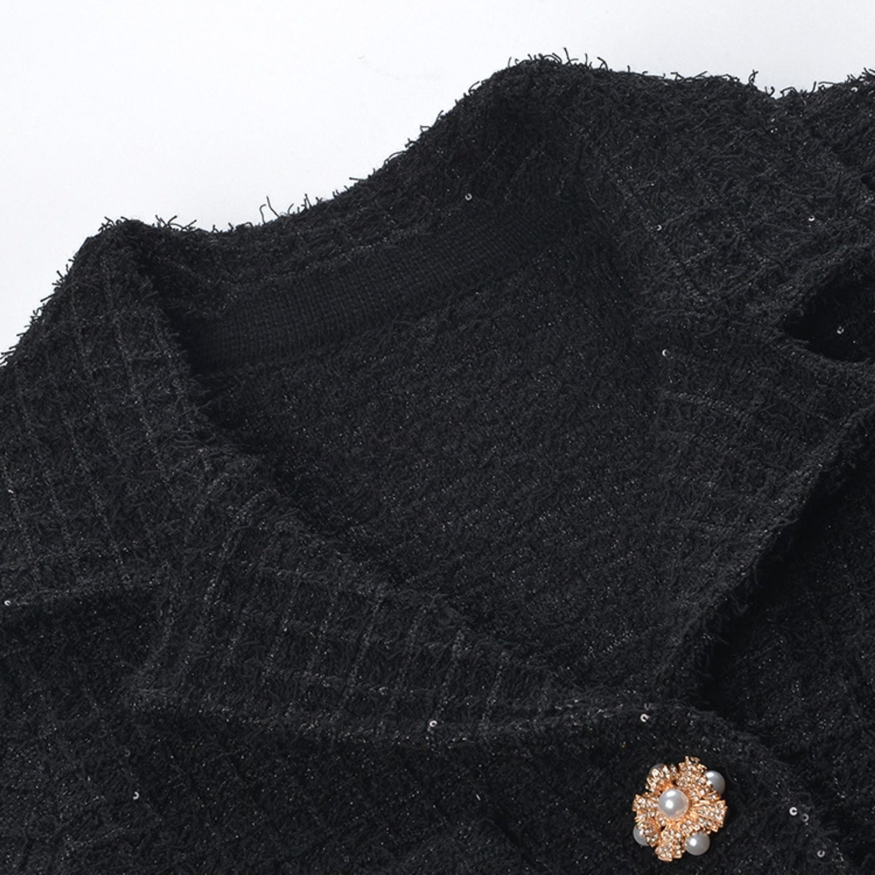 Waffleknit black dress with pleated edge thighlength and front button fastening