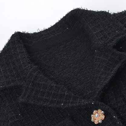 Waffleknit black dress with pleated edge thighlength and front button fastening