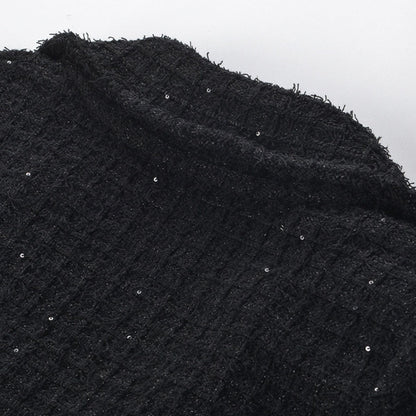 Black jacket with long sleeves notched lapels two front patch pockets front button fastening and waffleknit texture Made of 80% polyester 20% cotton Black skirt with pleated edge and waffleknit detail Composed of 80% polyester 20% cotton