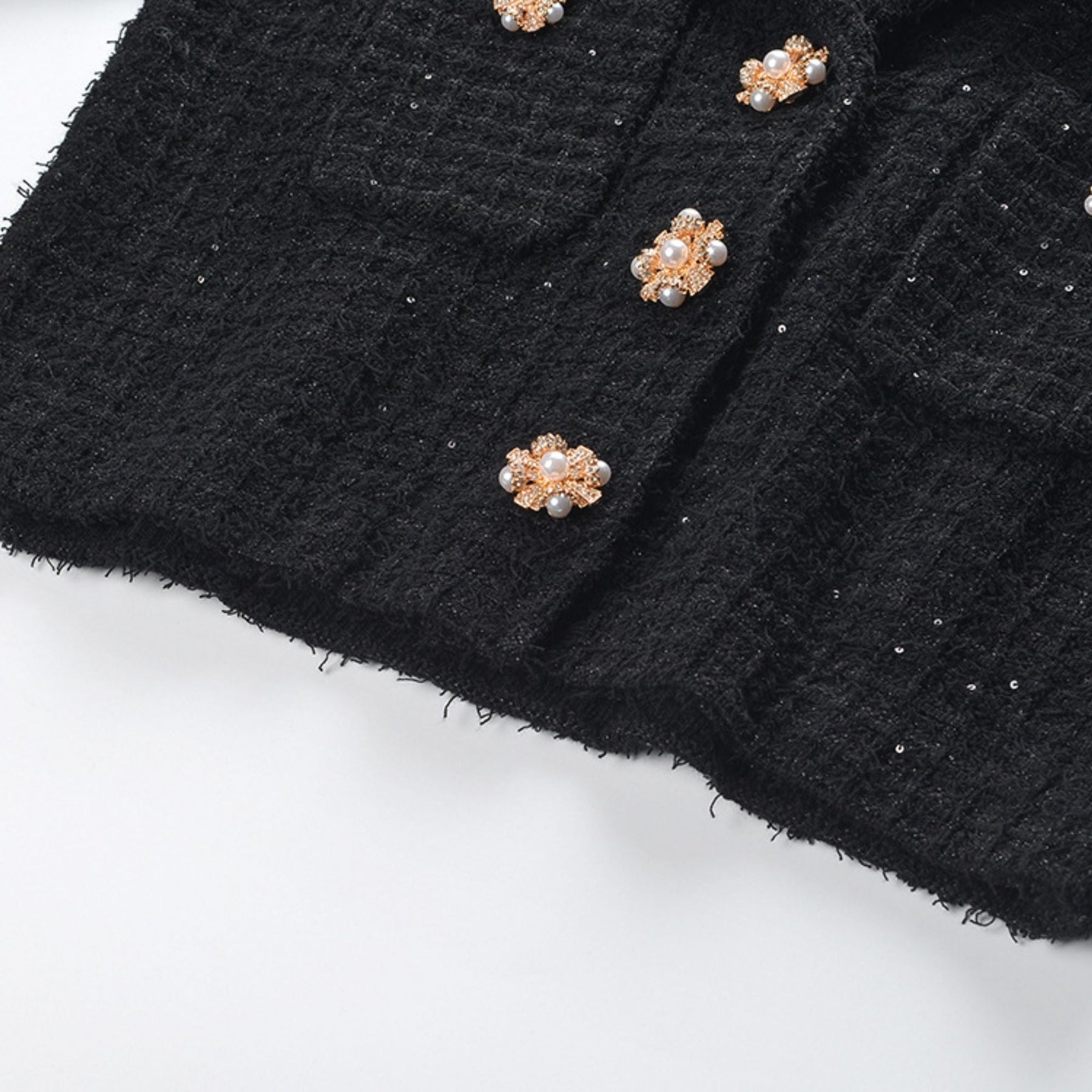 Bold black jacket with notched lapels long sleeves front patch pockets and unique waffleknit texture Made of 80% durable polyester and 20% comfortable cotton Chic black skirt with pleated edge in a modish thigh length Composed of 80% highquality polyester and 20% soft cotton