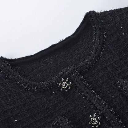 Black waffleknit dress with pleated edge thigh length matching jacket